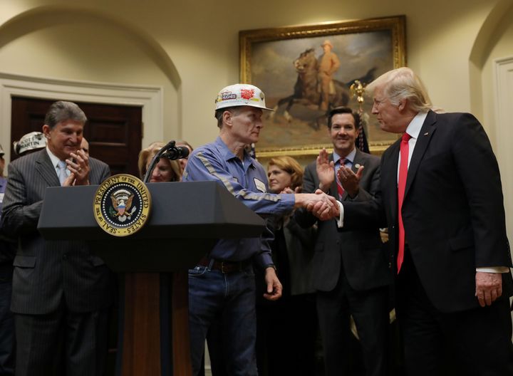 A coal miner shakes hands with President Donald Trump as Trump prepares to sign Resolution 38, which nullified the Stream Protection Rule.