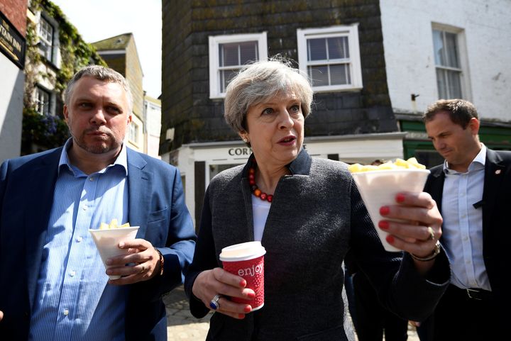 Theresa May enjoys some chips during a campaign stop on May 2, 2017 in Mevagissey, Cornwall.