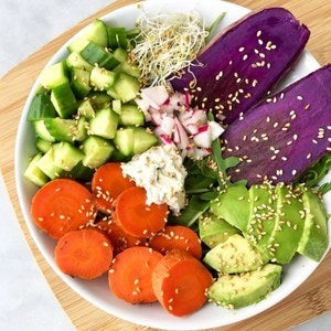 <p>Buddha Bowl with arugula, purple sweet potato, radish, cucumbers, roasted carrots, avocado, sprouts and chive</p>