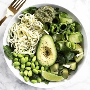 <p>Fresh spinach, zoodles, edamame, and zucchini ribbons, topped with a dollop of herb pesto and a sprinkle of chia seeds</p>