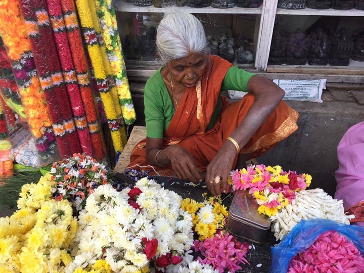 A woman prepares offerings for the Goddess