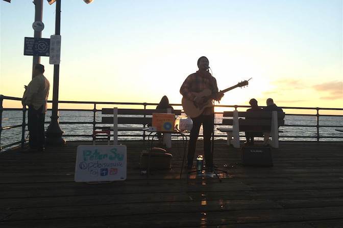 Busker at sunset on Santa Monica Pier — looking for connection