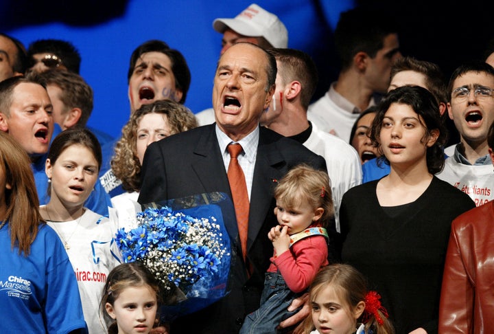 Chirac sings the French national anthem during a re-election campaign rally on March 12, 2002.