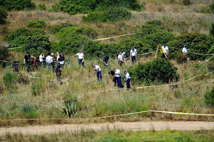 The search for Madeleine McCann has so far cost £11 million. British and Portuguese police are seen here in 2014 searching a patch of scrubland just outside the town of Praia da Luz