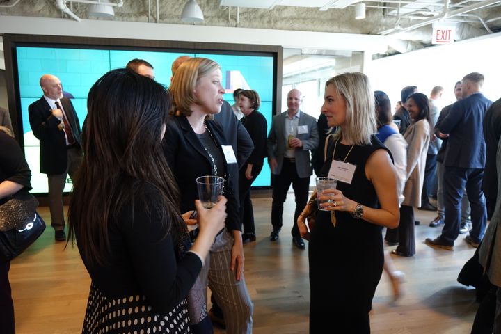 Melissa Morris, Furniture Advisor with CBRE and key organizer of the event chats with guests at the pre-discussion happy hour.
