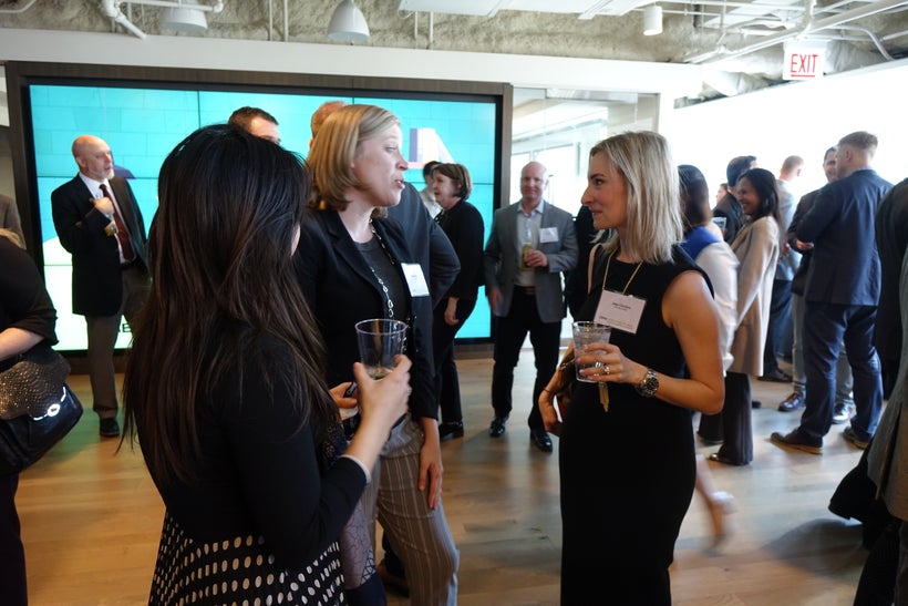 Melissa Morris, Furniture Advisor with CBRE and key organizer of the event chats with guests at the pre-discussion happy hour