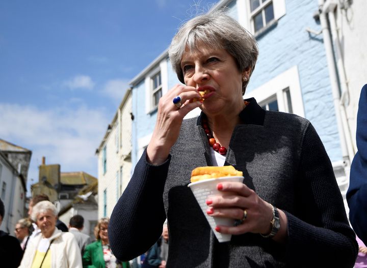 Theresa May tucks into a cone of chips in Mevagissey