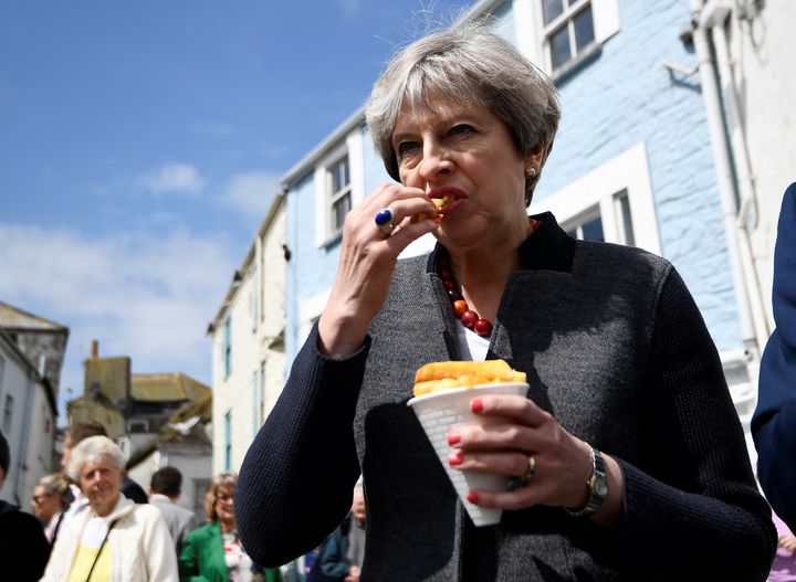 Theresa May looking t-o-t-a-l-l-y normal as she has a snack on the campaign trail
