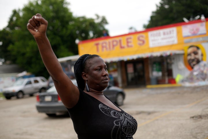 Veda Washington protests the fatal police shooting of her nephew Alton Sterling outside the Triple S Food Mart.