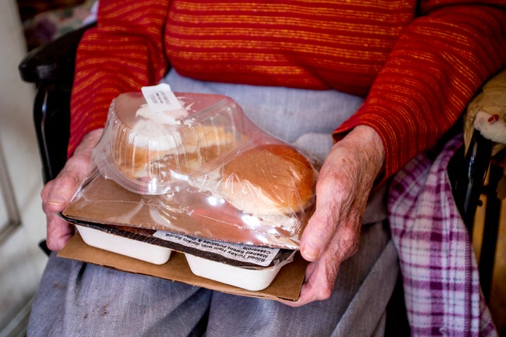 Josephine Hayward, 93, of Portland, holds a meal of ham with a raisin sauce, sweet potatoes, a broccoli casserole, bread, and apple pie for dessert, that was delivered to her as part of the Southern Maine Agency on Aging's Meals on Wheels program.