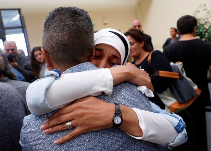 Syrian refugees hug each other as they reunite at Rome’s Fiumicino international airport, Italy, through ‘humanit