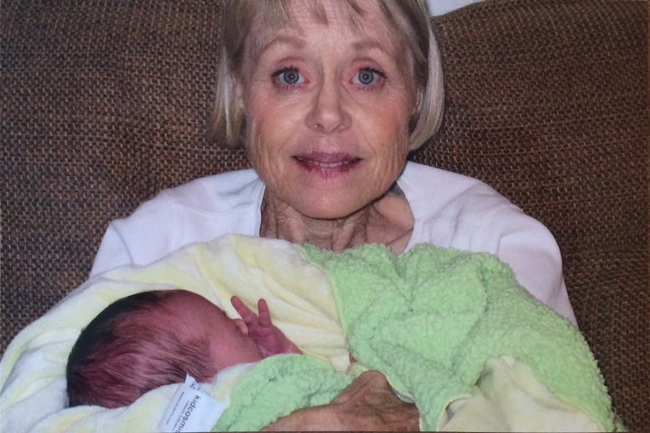 My mom holding my firstborn in 2005.