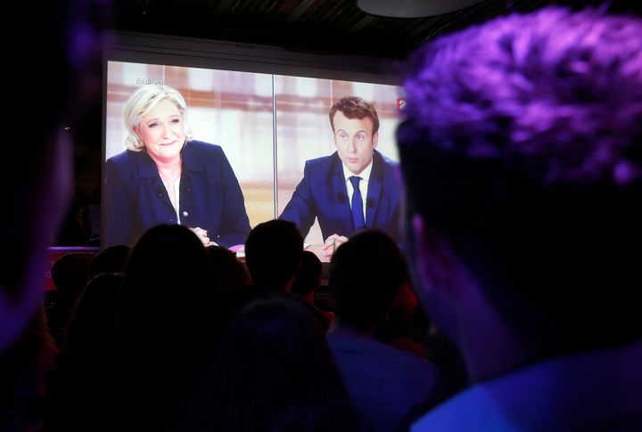 Macron's supporters watch the debate on a huge screen 