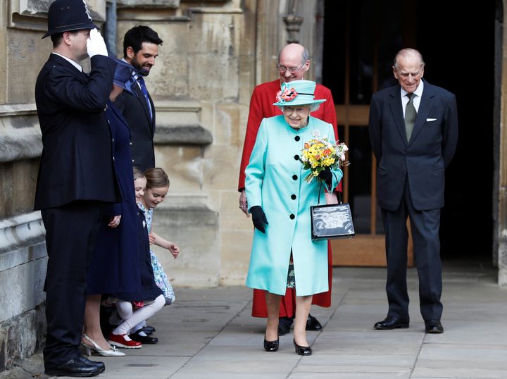 Girls curtsey as Britain's Queen Elizabeth and prince Philip leave the Easter Sunday service in Windsor Castle, in Windsor, April 16.