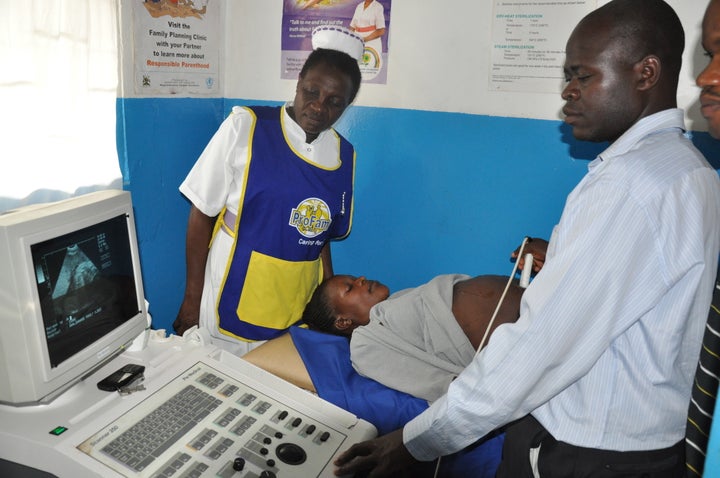 Mama Maria examines one of her patients at the Mama Maria Maternity Ward, located on the outskirts of Kampala, Uganda.