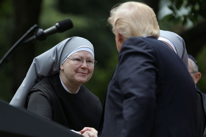 U.S. President Donald Trump shakes hands with a nun of the Little Sisters of The Poor during a National Day of Prayer event.