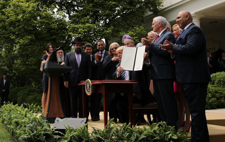U.S. President Donald Trump shows off an Executive Order on Promoting Free Speech and Religious Liberty during a National Day of Prayer event at the Rose Garden of the White House in Washington D.C., U.S., May 4, 2017.
