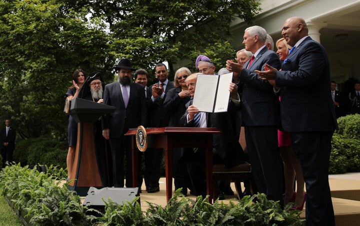 U.S. President Donald Trump shows off an Executive Order on Promoting Free Speech and Religious Liberty during a National Day