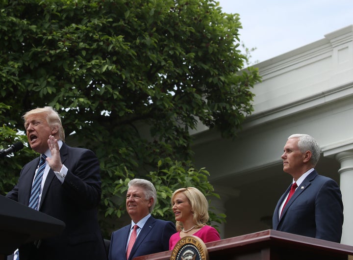 President Donald Trump speaks while Vice President Mike Pence, Pastor Paula White, and Pastor Jack Graham listen during a Nat