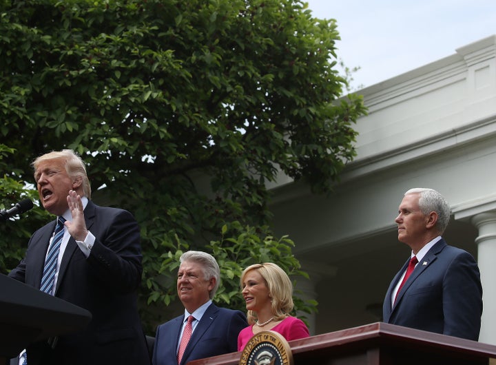 President Donald Trump speaks while Vice President Mike Pence, Pastor Paula White, and Pastor Jack Graham listen during a National Day of Prayer event in the Rose Garden, at the White House, on May 4, 2017 in Washington, DC.