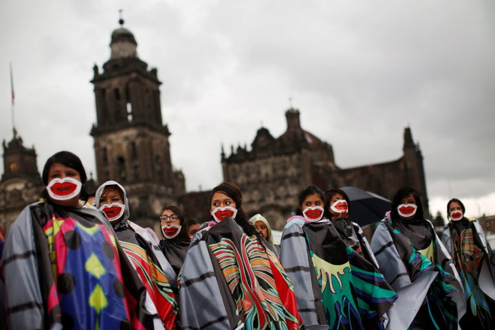 Pro-abortion activists wearing masks demand the decriminalization of abortion in Mexico, Sept. 28, 2016.