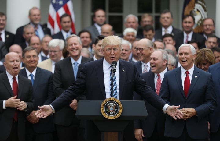 President Donald Trump gathers with Vice President Mike Pence, right, and gleeful congressional Republicans in the White House Rose Garden on Thursday after the House narrowly approved the American Health Care Act.