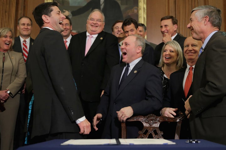 Speaker of the House Paul Ryan (R-Wis.), left, laughs along with Republican House members after the vote to repeal the A