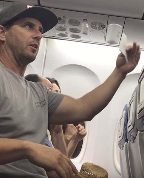 Brian Schear gestures during the row on a Delta flight