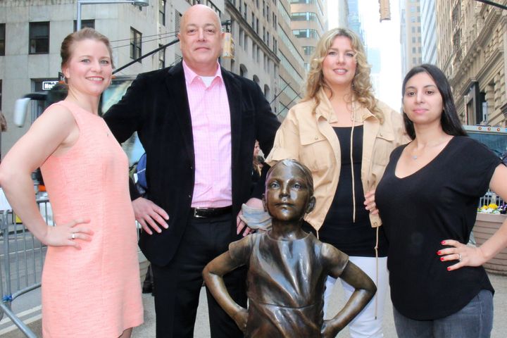 <p>(left to right) Survivors of childhood sexual abuse, Bridie Farrell, Steve Jimenez, Amy Granberg and Ana Wagner strike their power poses with the Fearless Girl statue. </p>