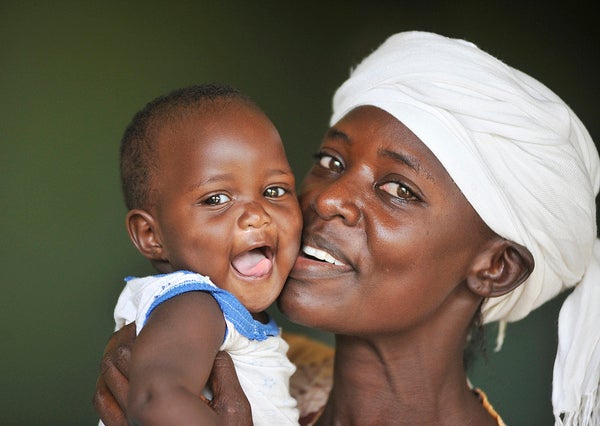 An HIV-positive mother in Kenya holds her HIV-negative baby.