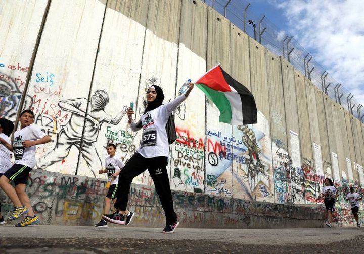 A runner takes part in the 2017 Palestine Marathon now run by the Palestine Olympic Committee