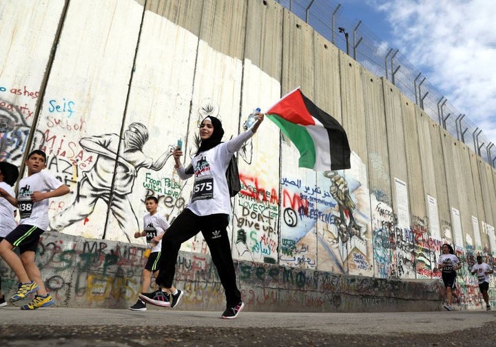 <p>A runner takes part in the 2017 Palestine Marathon now run by the Palestine Olympic Committee</p>