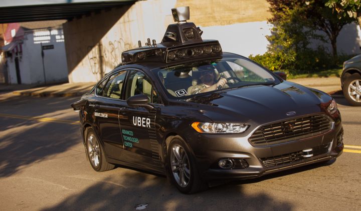 A driverless Uber Ford Fusion drives down the street in Pittsburgh, Pennsylvania in September. Rival Waymo claims Uber stole trade secrets to advance its driverless car research.