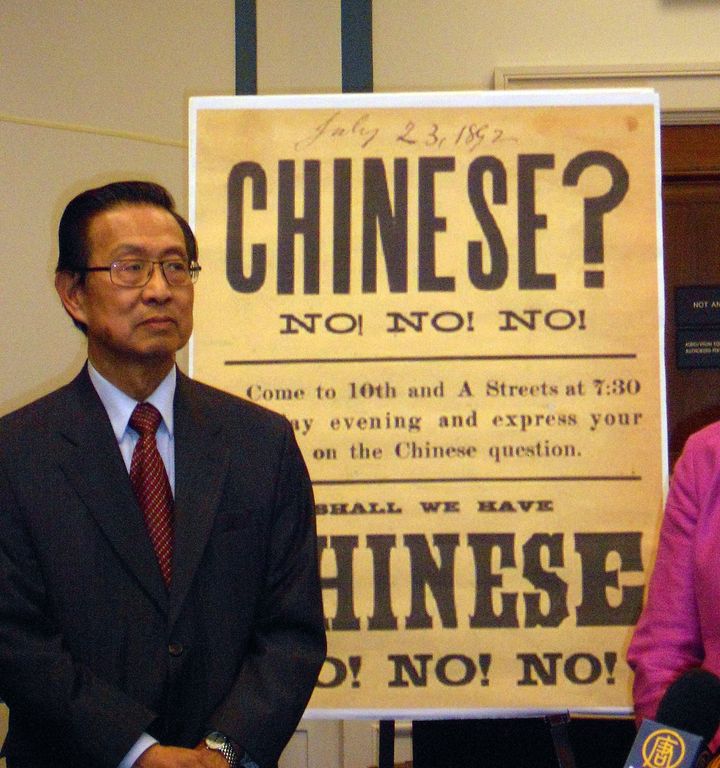 Michael Lin, chair of the 1882 Project, a coalition of rights groups seeking a statement of regret over the Chinese Exclusion Act, stands in front of a reproduction of a 19th-century anti-Chinese immigration sign. 