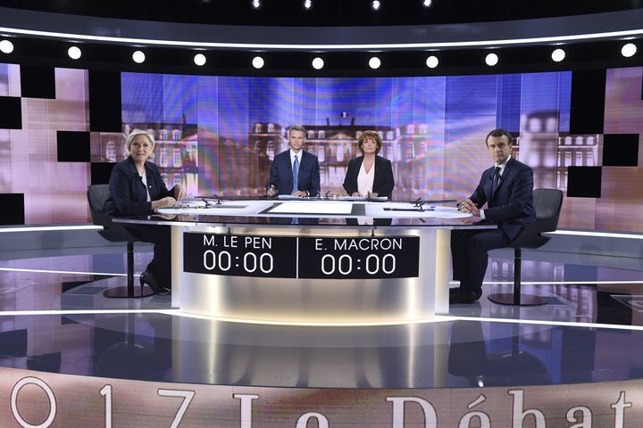 French presidential election candidates Marine Le Pen and Emmanuel Macron pose prior to the start of a live broadcast face-to-face debate.