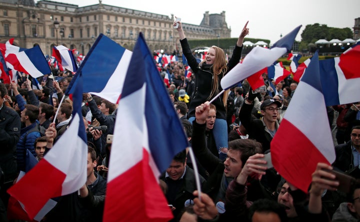 Supporters of Emmanuel Macron celebrate near the Louvre museum after results were announced in the second round vote on May 7, 2017.