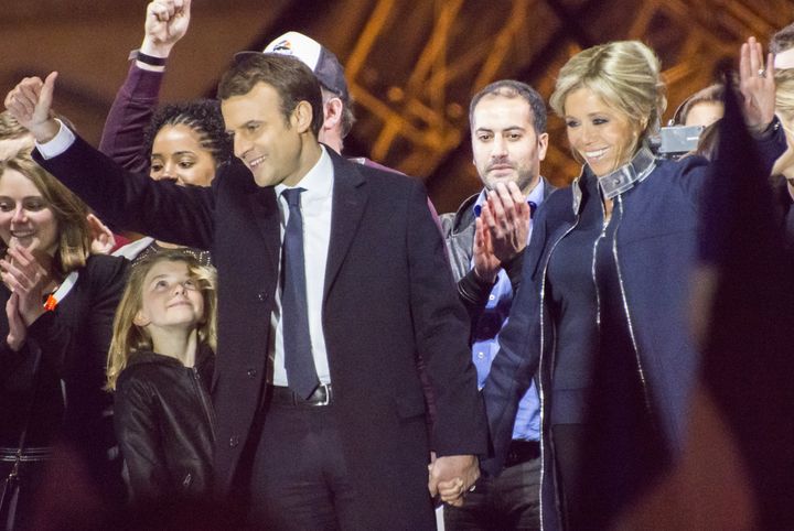 Macron and his wife Brigitte Trogneux celebrate his victory outside the Louvre on Sunday