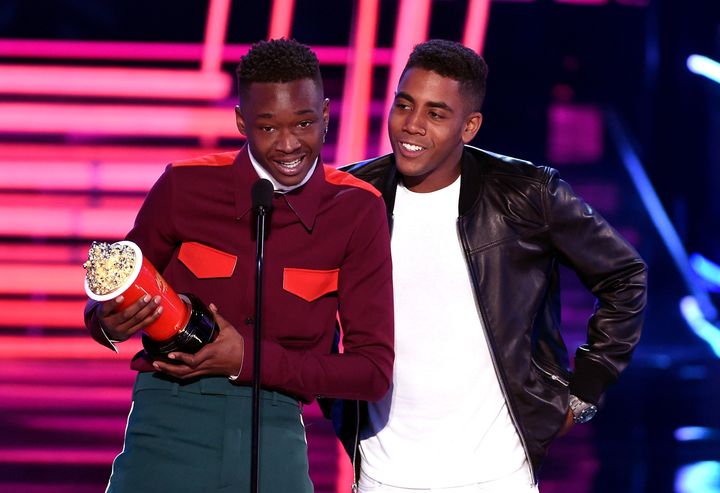 Actors Ashton Sanders and Jharrel Jerome accept the award for best kiss for "Moonlight" during the 2017 MTV Movie And TV Awards.