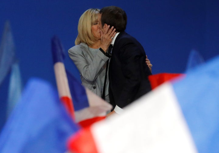 Trogneux kisses Macron before he gives a speech in Paris on April 23, 2017.