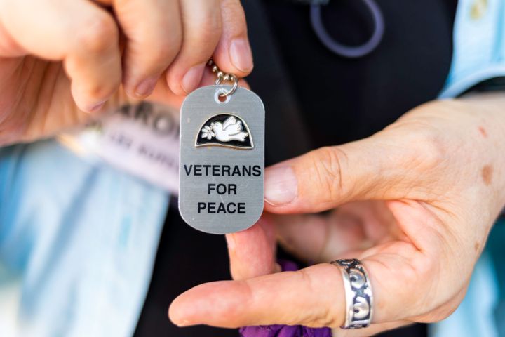 A participant on the Veterans for Peace tour of Vietnam shows a necklace she wears with the group's name on it.