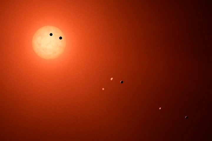 An illustration shows the seven TRAPPIST-1 planets as they might look as viewed from Earth.