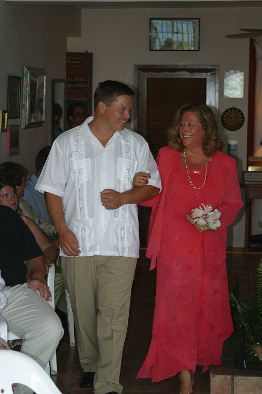 Groomsman Kevin Borland escorting Mother of the Bride Robin Corridon to her seat at the ceremony