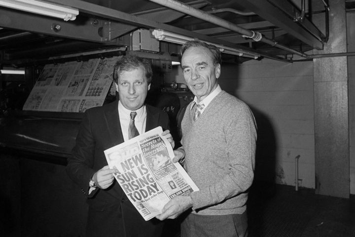 MacKenzie and Murdoch pose holding a copy of The Sun