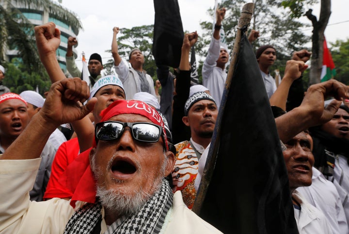 Indonesian hardline Muslims react after hearing a verdict on Jakarta's first non-Muslim and ethnic-Chinese Christian governor Basuki Tjahaja Purnama's blasphemy trial outside the court in Jakarta, Indonesia May 9, 2017.