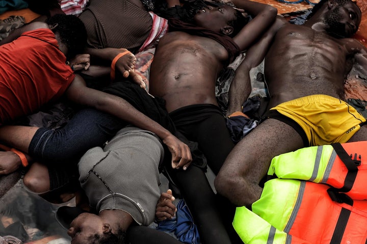 The bodies of refugees and migrants who died on a rubber boat lie on a boat in the Mediteranean Sea, north of Libya, on October 5, 2016.