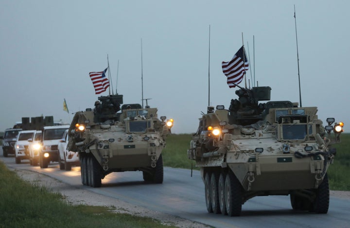 U.S military vehicles and Kurdish fighters from the People's Protection Units (YPG) drive in the town of Darbasiya next to the Turkish border, Syria, April 28, 2017.