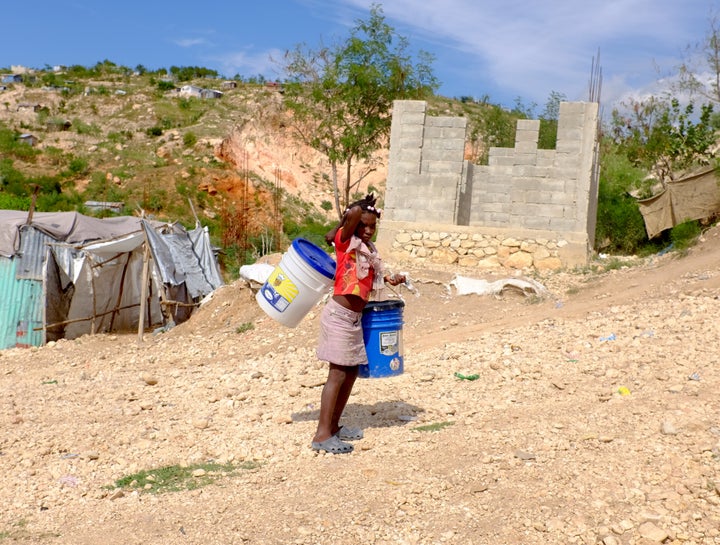 The situation remains much the same in the camps as this photo shows. Taken in December 2015, almost six years post earthquake, people to this day are still living in tents and under plastic and tin. There is no sanitary infrastructure while cholera lurks. Children are vulnerable in many ways. Would you want to send your children to this “improved” setting?