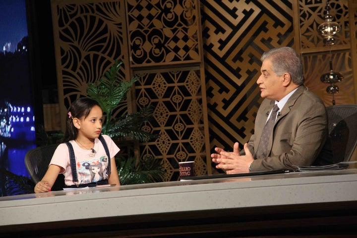 <p><em>Nada, a 10-year-old girl who lost her father, brigadier general Ahmed Abdel-Nabi, during an ISIS terrorist attack, with Ossama Kamal on DMC television.</em></p>