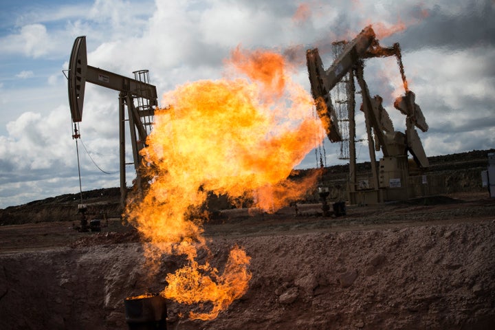A gas flare is seen at an oil well site outside Williston, North Dakota, on July 26, 2013. Gas flares are created when excess
