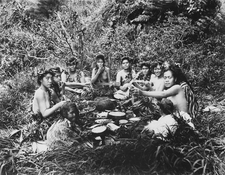 Native Hawaiians eating a meal together. 